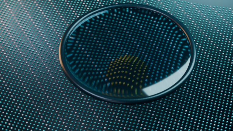 Close-up of a glass lens reflecting light on a high-tech metallic surface